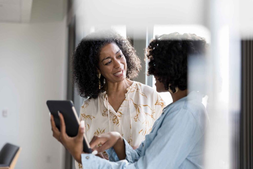 Employee Assistance Programs (EAPs): an HR representative showing an employee EAP options on an Ipad.