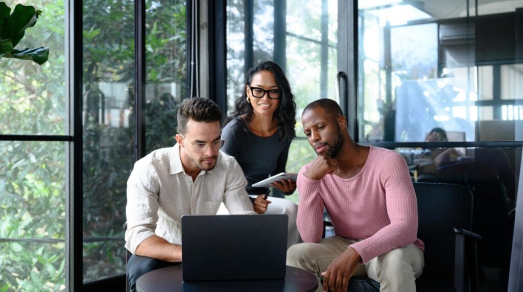 Diverse Business Team displaying the company values by collaborating in a modern office with natural light.