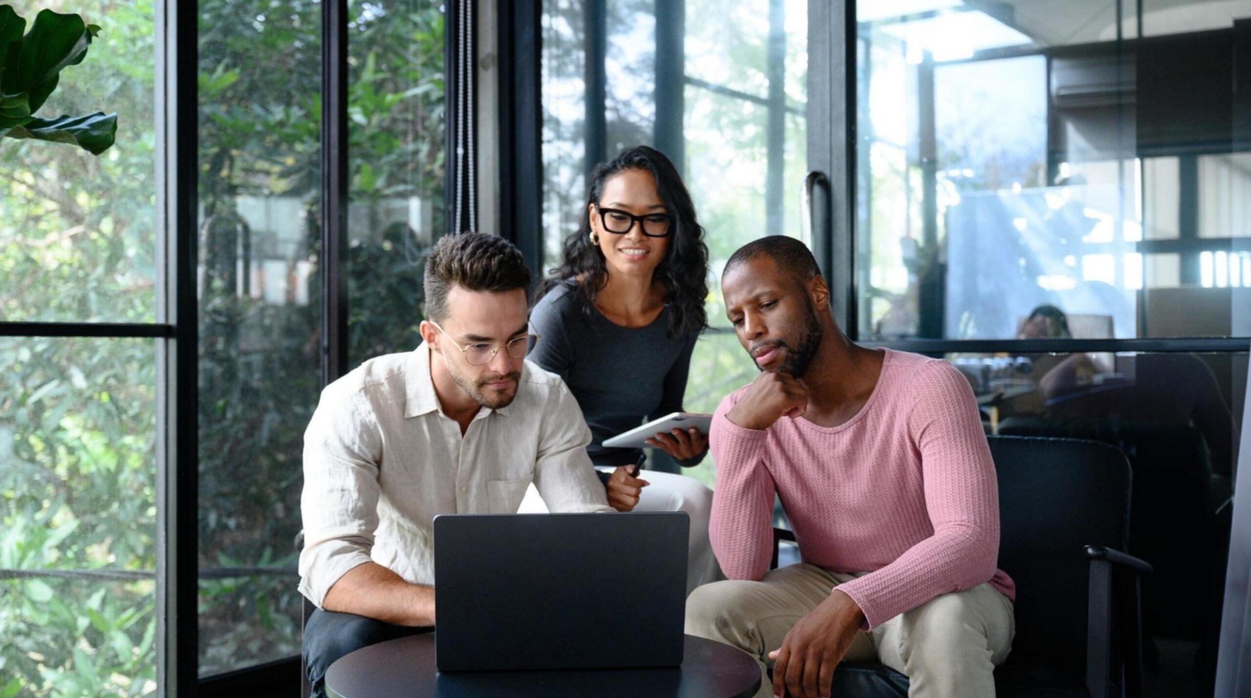 Diverse Business Team displaying the company values by collaborating in a modern office with natural light.