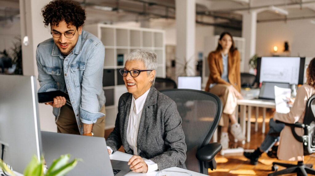 Multigenerational team collaborating in a diverse workplace.
