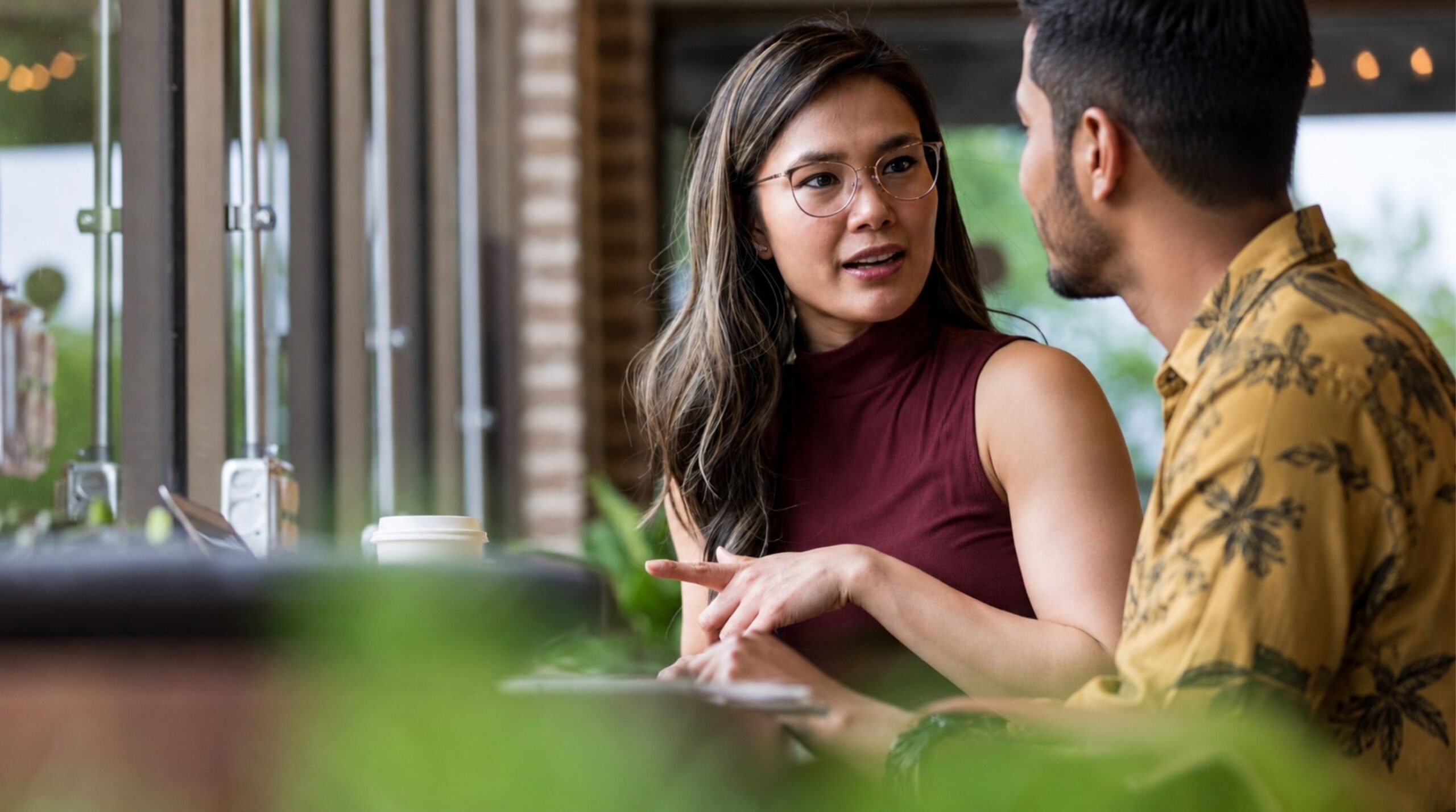 Two colleagues having a respectful conversation in a professional setting.